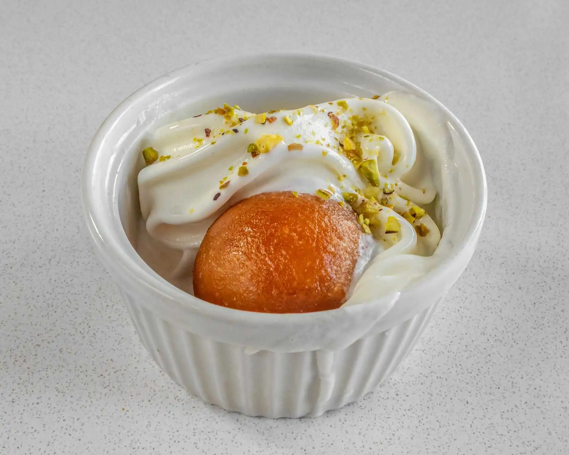 Gulab jamun dessert with cream and pistachios at Virk Dhaba London Ontario