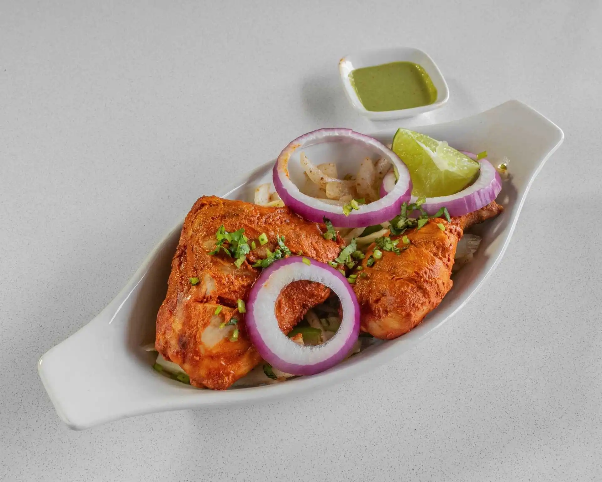 Char-grilled tandoori chicken with onion and lime at Virk Dhaba London Ontario